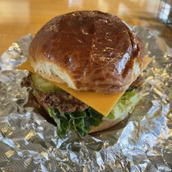 The Farmcart - Chicken sandwich cheddar cheese lettuce pickle and cart sauce on an in-house Hawaiian roll.