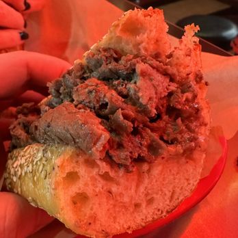 Stoli's Steaks - a hand holding a sandwich - Cheesesteaks Near Me - Philadelphia, Pennsylvania Stoli's Steaks - a hand holding a sandwich - Cheesesteaks Near Me - Philadelphia, Pennsylvania