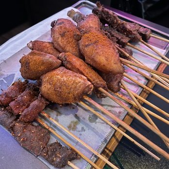 Xinjiang BBQ - Wings, beef tongue, enoki wrapped in bacon, beef - Asian Fusion Near Me - San Diego, California Xinjiang BBQ - Wings, beef tongue, enoki wrapped in bacon, beef - Asian Fusion Near Me - San Diego, California