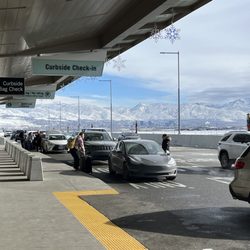 First Chair Transport Co - Salt Lake City airport curbside on a clear winter day. Mountains in the background. Typical pickup drop off conditions we see during season.