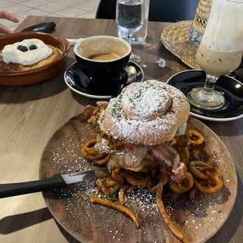 Kaffe Haus - Fried chicken sandwich, with Tres Leches pancakes in the background - Breakfast & Brunch Near Me - San Juan, Puerto Rico Kaffe Haus - Fried chicken sandwich, with Tres Leches pancakes in the background - Breakfast & Brunch Near Me - San Juan, Puerto Rico