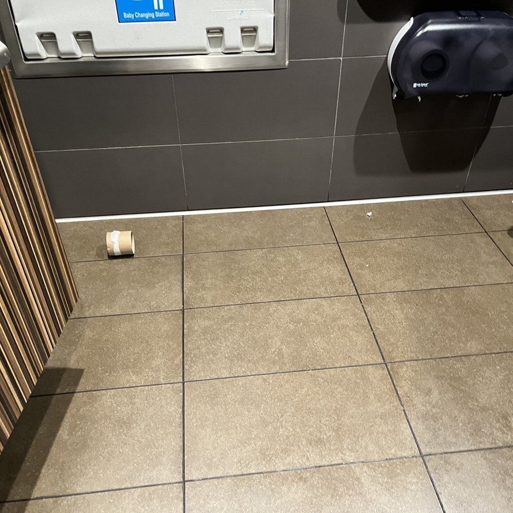 McDonald's - Dirty Floor with empty toilet paper roll on the floor - Fast Food Near Me - Ephraim, Utah