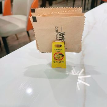 Ah Ma’s kitchen  - Disposal gloves on the table. We love the little yellow clip thingy warning  about hot chicken! Lol. Cute! - Asian Fusion Near Me - San Francisco, California