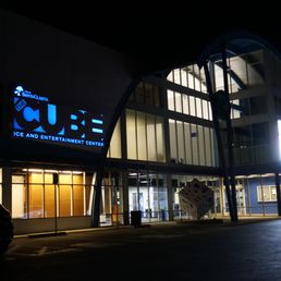 Front of the building at night.
