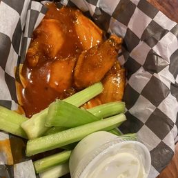 a basket of wings and celery