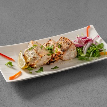 Red Onion - Cubes of Salmon Marinated in Yogurt, Ginger, & Garlic Cooked in the Tandoor Oven. - Vegetarian Near Me - New York, New York Red Onion - Cubes of Salmon Marinated in Yogurt, Ginger, & Garlic Cooked in the Tandoor Oven. - Vegetarian Near Me - New York, New York