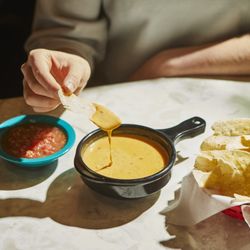 Chuy's - QUESO - Blend of melted cheese, Green Chile & Ranchero Sauces. Add seasoned ground beef, guacamole & pico de gallo.