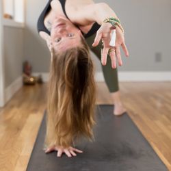 Aya Yoga Oasis - Owner Carrie Johnson exploring Flip Dog yoga pose.