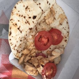 a tortilla with chicken and tomatoes a tortilla with chicken and tomatoes