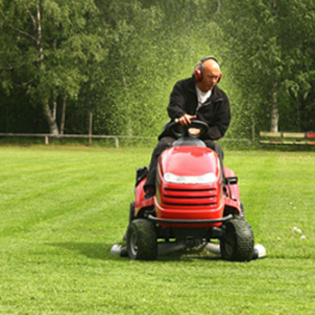 Second Nature Gardens - a man riding a lawn mower - Landscaping Near Me - Saint Joseph, Michigan Second Nature Gardens - a man riding a lawn mower - Landscaping Near Me - Saint Joseph, Michigan