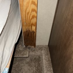 Travelcamp RV - Jacksonville - Mold & water damage underneath slide trim; the exterior of this slide out is taped up & sprayed black.
