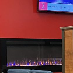 Wendy's - Cozy nook with fireplace and comfy-looking seating