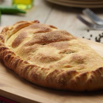 Pizza Twist -  a piece of bread on a cutting board - Pizza Near Me - Selma, California