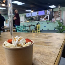 Love In Action Cafe - Mango Smoothie Bowl, Eating area next to free bookcase!