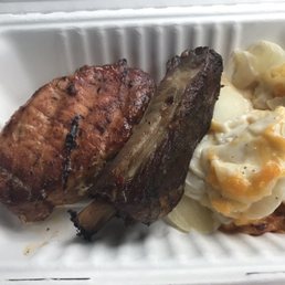 Scalloped potatoes, baked pork chop, and bbq ribs.