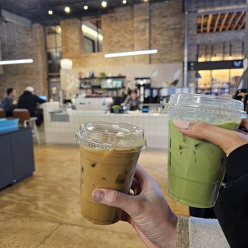 Frgmnt Coffee - a person holding a cup of iced coffee - Cafes Near Me - Minneapolis, Minnesota