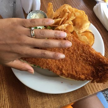 The Breezeway - The big fish filet. There is a bun under there to make a sandwich. - New American Near Me - Sanford, Florida The Breezeway - The big fish filet. There is a bun under there to make a sandwich. - New American Near Me - Sanford, Florida