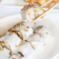Ocean Palace - Delicate rice noodle rolls stuffed with juicy shrimp, paired with a golden, crunchy breadstick, perfect for a flavorful bite.