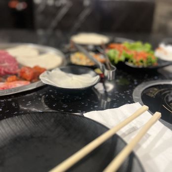 Q-POT - a variety of food on a table with chopsticks - Korean Near Me - San Jose, California Q-POT - a variety of food on a table with chopsticks - Korean Near Me - San Jose, California