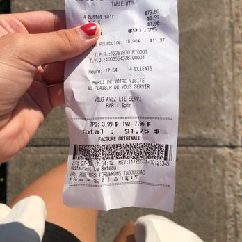 Le Bateau - a person holding a receipt - Restaurants Near Me - Tadoussac, Quebec
