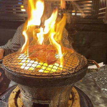 Old Village - a large grill with flames on it - Korean Near Me - Seattle, Washington