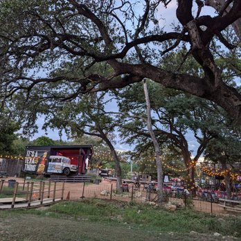 Armadillo Den - View of Seating areas from dog park - Bars Near Me - Austin, Texas Armadillo Den - View of Seating areas from dog park - Bars Near Me - Austin, Texas