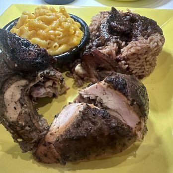 Cutlass Grille - 1/4 white meat Jerk chicken with a side of rice and peas and Mac and cheese - Caribbean Near Me - Chesapeake, Virginia Cutlass Grille - 1/4 white meat Jerk chicken with a side of rice and peas and Mac and cheese - Caribbean Near Me - Chesapeake, Virginia