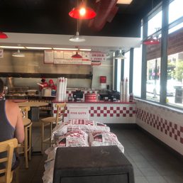 a man sitting at a table in a fast food restaurant