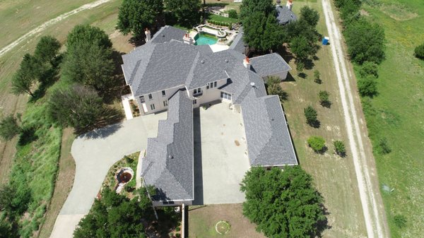 Drone Photos Of Our Work - Our Team Has Experience Working With Multiple Types of Roofing, Including Shingles, Metal, And Thermoplastic.
When you need work done on your roof, it’s important to choose a team with experience working on the specific material your roof is made of. Asphalt shingles and metal roofing, for example, behave very differently and have different requirements when it comes to installation and repair. While some roofing companies only work with one material, our team at Matthews Roofing LLC has extensive experience working with multiple types of roofing—specifically, asphalt shingles, metal roofing, and flat thermoplastic roofing for commercial applications.
No matter which type of roofing our team is working with on a project, we always take the time to check every step of the process and make sure everything is installed correctly. We are committed to delivering high-quality workmanship, and we pride ourselves on getting the job done right the first time. Whether you hire our team to repair storm damage, replace aging shingles or metal, or otherwise service your roof, you can rest assured that you won’t have to call us back to fix a problem in our work. If you suspect that your roof could use some attention, we encourage you to give us a call to schedule an assessment—we’ll take note of any problems and provide the solutions you need.
Our team is proud to serve the Decatur, Texas community, and we want to help you do what’s best for your roof. If you need a roofing company with the right experience to work on multiple types of roofing, just give us a call. Drone Photos Of Our Work - Our Team Has Experience Working With Multiple Types of Roofing, Including Shingles, Metal, And Thermoplastic.
When you need work done on your roof, it’s important to choose a team with experience working on the specific material your roof is made of. Asphalt shingles and metal roofing, for example, behave very differently and have different requirements when it comes to installation and repair. While some roofing companies only work with one material, our team at Matthews Roofing LLC has extensive experience working with multiple types of roofing—specifically, asphalt shingles, metal roofing, and flat thermoplastic roofing for commercial applications.
No matter which type of roofing our team is working with on a project, we always take the time to check every step of the process and make sure everything is installed correctly. We are committed to delivering high-quality workmanship, and we pride ourselves on getting the job done right the first time. Whether you hire our team to repair storm damage, replace aging shingles or metal, or otherwise service your roof, you can rest assured that you won’t have to call us back to fix a problem in our work. If you suspect that your roof could use some attention, we encourage you to give us a call to schedule an assessment—we’ll take note of any problems and provide the solutions you need.
Our team is proud to serve the Decatur, Texas community, and we want to help you do what’s best for your roof. If you need a roofing company with the right experience to work on multiple types of roofing, just give us a call.