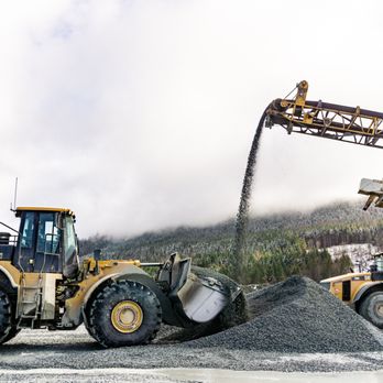 Washington Rock Quarries - a wheel loader grabs a scoop of freshly made gravel at Kapowsin Quarry - Building Supplies Near Me - Orting, Washington Washington Rock Quarries - a wheel loader grabs a scoop of freshly made gravel at Kapowsin Quarry - Building Supplies Near Me - Orting, Washington