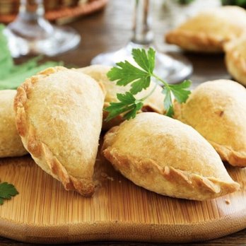 Oh Empanadas - a plate of empanadas on a table - Food Trucks Near Me Oh Empanadas - a plate of empanadas on a table - Food Trucks Near Me
