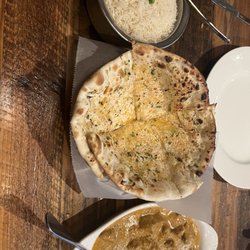 CurryGrill - Restaurant & Sports Bar - Spicy butter chicken w/ garlic and cheese naan