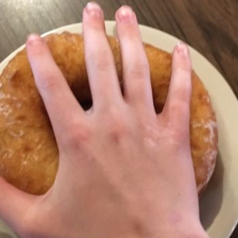T Pattenn Cafe - a hand holding a donut - Fast Food Near Me - Orr, Minnesota T Pattenn Cafe - a hand holding a donut - Fast Food Near Me - Orr, Minnesota