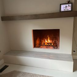 Pulido's General Construction - New look in this fireplace new tile,mantle and paint!!