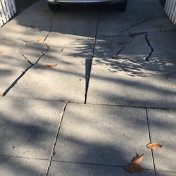 Oscar Concrete - Before: Driveway was really torn up from the roots.