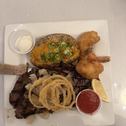 The Steakhouse & Lodge - 16 oz ribeye, loaded baked potato and added3 shrimp.