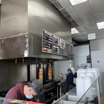 Al Madina Grill - a man working in a kitchen - Halal Near Me - Cincinnati, Ohio