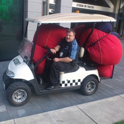 The friendly security guard taking away the red cushions at the end of the day