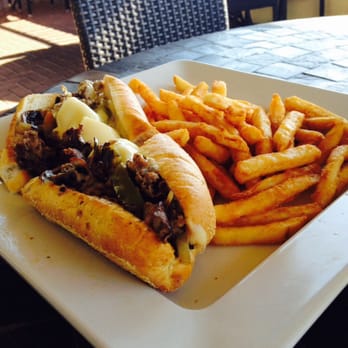 Sunset Grille - Philly cheese steak with shrooms, peppers, onions. The buns are flown in from Philly. This thing is phenomenal. - Sports Bars Near Me - Marco Island, Florida Sunset Grille - Philly cheese steak with shrooms, peppers, onions. The buns are flown in from Philly. This thing is phenomenal. - Sports Bars Near Me - Marco Island, Florida