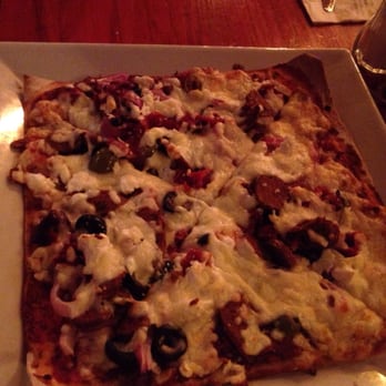 Garage Café - Pizza with sundried tomato olives merguez feta - Burgers Near Me - Verdun, Quebec Garage Café - Pizza with sundried tomato olives merguez feta - Burgers Near Me - Verdun, Quebec