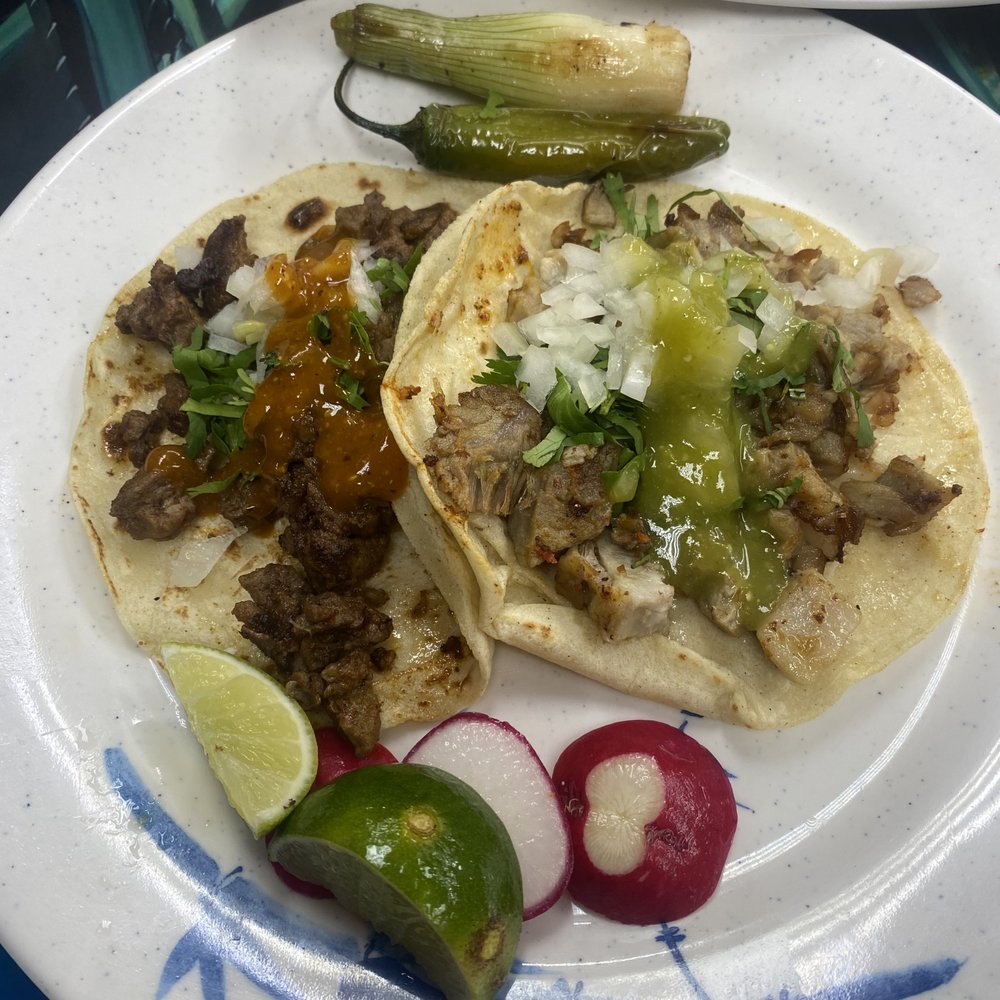 Carnitas and Asada taco with fresh lime, radish and charred onion & jalapeño