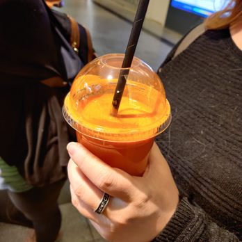 Station Vitamine - a woman holding a cup of juice - Juice Bars & Smoothies Near Me - Montreal, Quebec Station Vitamine - a woman holding a cup of juice - Juice Bars & Smoothies Near Me - Montreal, Quebec