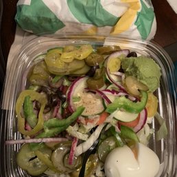 a salad in a plastic container on a table
