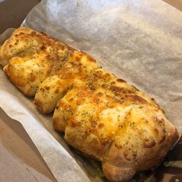 a cheesy bread roll in a box