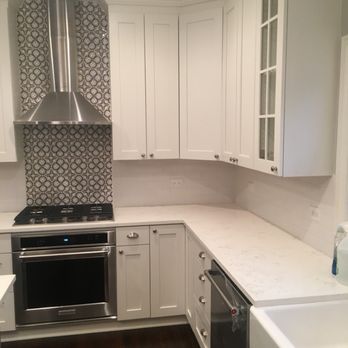 Midtown Remodeling - a kitchen with white cabinets and stainless steel appliances - General Contractors Near Me - Chicago, Illinois Midtown Remodeling - a kitchen with white cabinets and stainless steel appliances - General Contractors Near Me - Chicago, Illinois