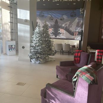 Wyndham Grand Jupiter at Harbourside Place - Lounge area in the back, festive for Christmas. - Hotels Near Me - Jupiter, Florida