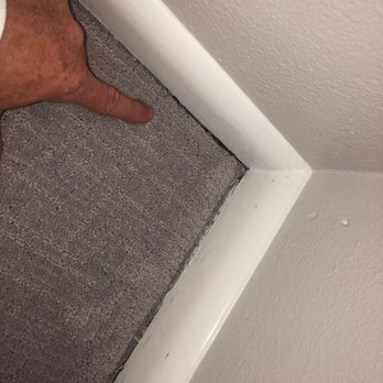 Great Floors - a man's hand reaching for the corner of a room - Flooring Near Me - Redmond, Washington