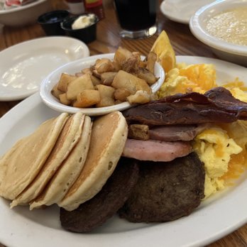Old Mill Restaurant - House Potatoes. Cheese Eggs, Bacon, Sausage and Country Ham. Also comes with biscuits and gravy (not pictured) and grits. - American Near Me - Pigeon Forge, Tennessee Old Mill Restaurant - House Potatoes. Cheese Eggs, Bacon, Sausage and Country Ham. Also comes with biscuits and gravy (not pictured) and grits. - American Near Me - Pigeon Forge, Tennessee
