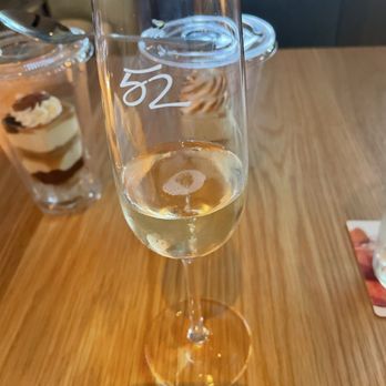 Seasons 52 - Glass of champagne, and the desserts (2). - New American Near Me - Troy, Michigan