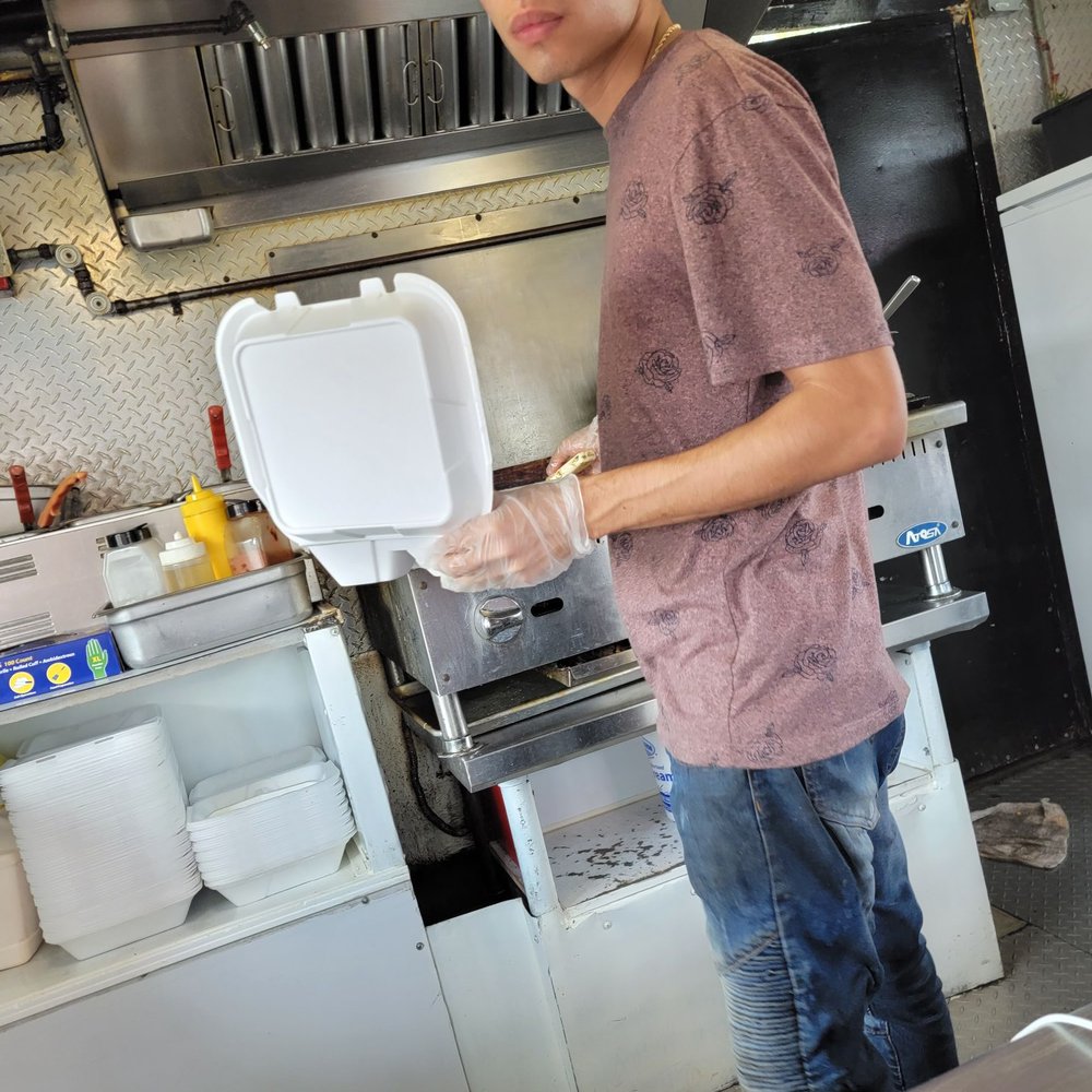a man preparing food in a commercial kitchen a man preparing food in a commercial kitchen